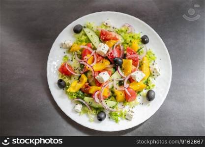 Greek salad dish with feta cheese and olives with vegetables for a healthy meal in a restaurant