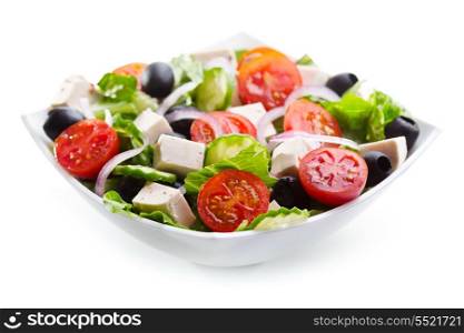 greek salad in a bowl on white background