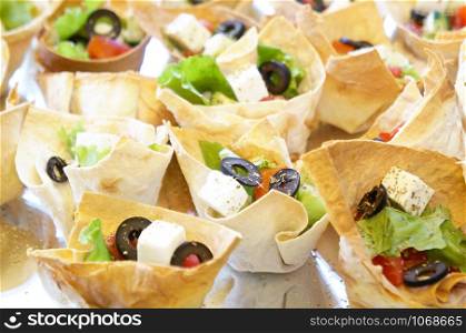 Greek salad in a small baked portions.