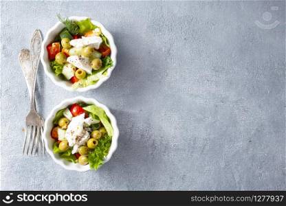 greek salad in white bowls, fresh salad