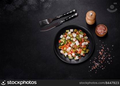 Greek salad of fresh cucumber, tomato, sweet pepper, lettuce, red onion, feta cheese and olives with olive oil. Greek salad with juicy tomatoes, feta cheese, lettuce, green olives, cucumber, red onion and fresh parsley