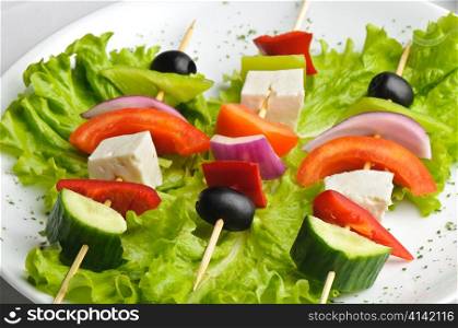greek salad on sticks served on plate. greek salad on sticks