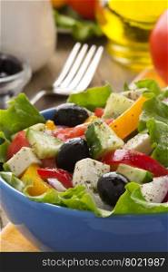 greek salad on wood background