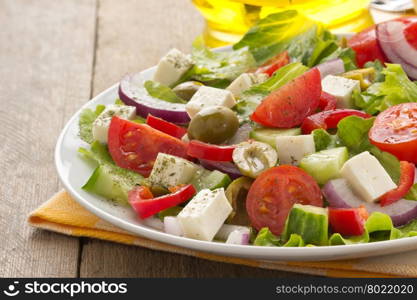 greek salad on wood background