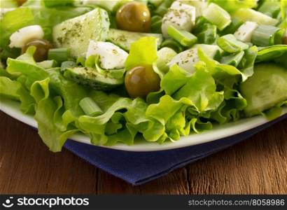 greek salad on wooden background