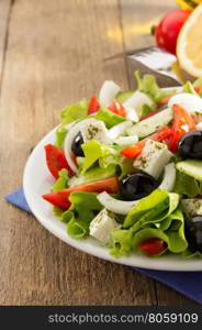 greek salad on wooden background