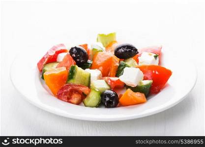 Greek salad with feta cheese macro on white plate