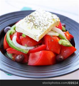 Greek salad with feta cheese, tomatoes and olives