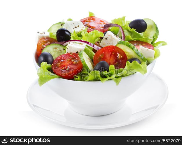 greek salad with fresh vegetables and feta cheese on white background