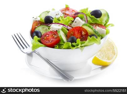 greek salad with fresh vegetables and feta cheese on white background