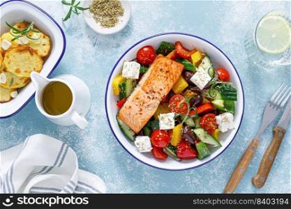 Greek salad with grilled salmon fish. Traditional mediterranean cuisine. Healthy food, diet. Top view