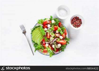 greek style avocado tomato salad with feta cheese, olives, cucumber, onion, lettuce