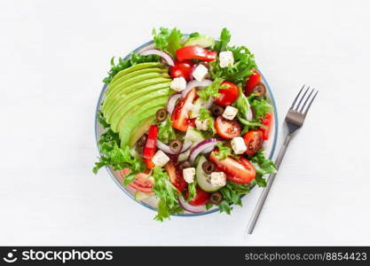 greek style avocado tomato salad with feta cheese, olives, cucumber, onion, lettuce