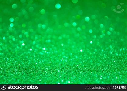 Green abstract glitter background with defocused lights bokeh. Green abstract glitter background with defocused lights