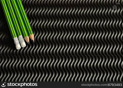 Green and black writing pencils