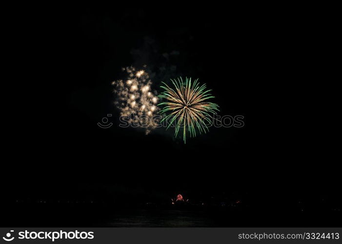 Green And Gold Fireworks. Colorful nighttime fireworks against a solid black sky over Lake Tahoe on the fourth of July holiday 2010