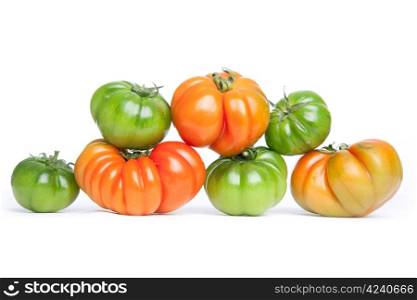 green and orange tomatoes on white background