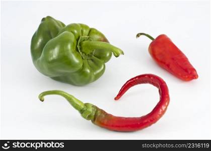 green and red bell peppers on white background
