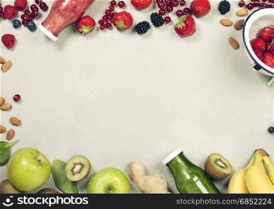 Green and red fresh juices or smoothies with fruit, greens, vegetables on grey background, top view, selective focus. Detox, dieting, clean eating, vegetarian, vegan, fitness, healthy lifestyle concept
