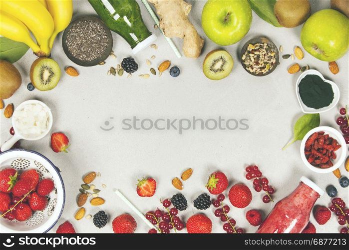 Green and red fresh juices or smoothies with fruit, greens, vegetables on grey background, top view, selective focus. Detox, dieting, clean eating, vegetarian, vegan, fitness, healthy lifestyle concept