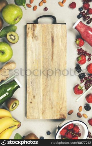 Green and red fresh juices or smoothies with fruit, vegetables on grey background, top view, selective focus. Detox, dieting, clean eating, vegetarian, vegan, fitness, healthy lifestyle concept