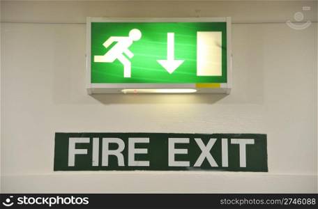 green and white warning sign glowing regarding fire exit emergency
