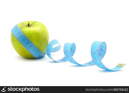 Green apple and measuring tape on white