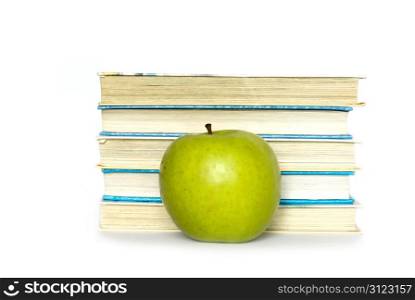 Green apple and stack of books for school