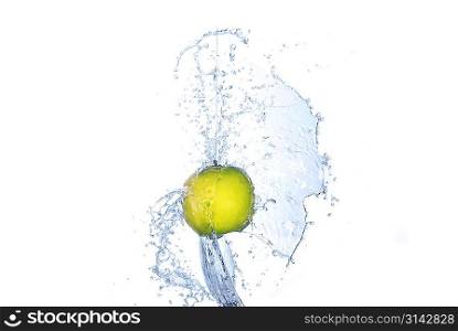 Green apple in splash of water isolated