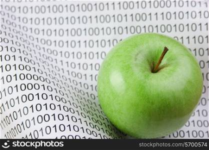green apple on a binary code