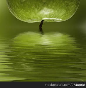 Green apple reflected in to the water