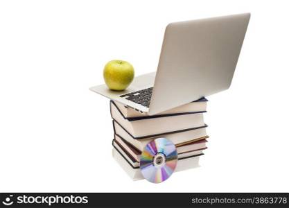 Green apple sitting on top of computer and books
