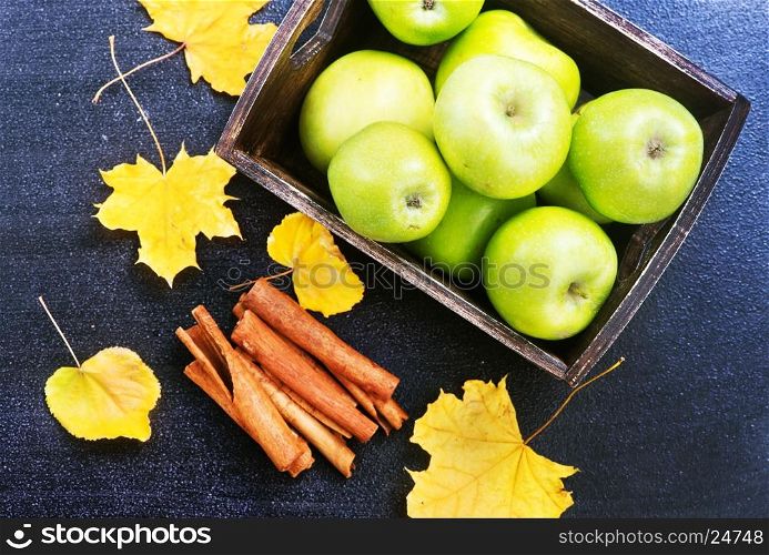 green apples and cinnamon on a table