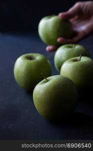 Green apples on a black background