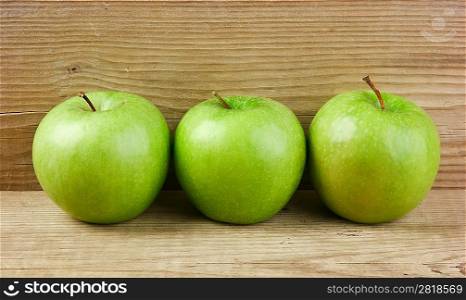 green apples on a wooden background