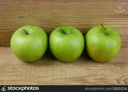green apples on a wooden background