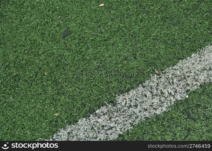 green artificial grass soccer field with white stripe