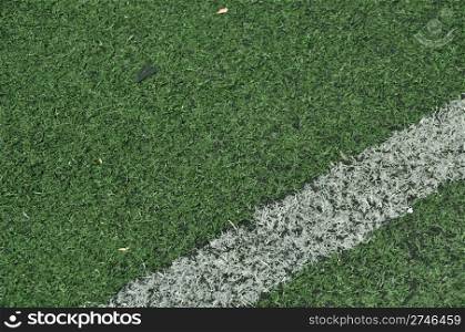green artificial grass soccer field with white stripe