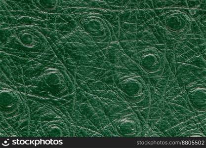 Green artificial or synthetic leather background with neat texture and copy space, colorful fabric s&le with leather-like finish aimed for upholstery, fashion, sewing or footwear projects