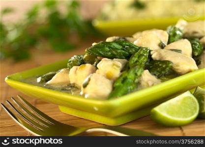 Green asparagus and chicken fricassee (Selective Focus, Focus on the asparagus tip in the middle of the image). Asparagus Chicken Fricassee