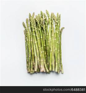 Green asparagus bunch on white background, top view, flat lay. Healthy seasonal food