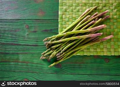 green asparagus fresh on wooden monochrome rustic table