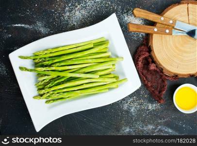 green asparagus on white plate on a table
