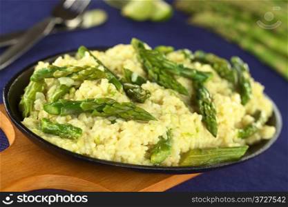 Green asparagus risotto (Selective Focus, Focus on the asparagus head one third into the risotto). Green Asparagus Risotto