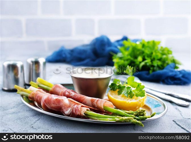 green asparagus with bacon on a table
