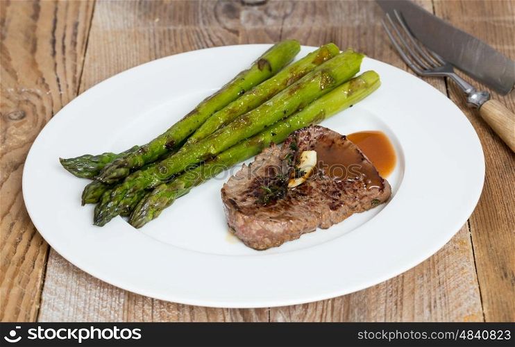 Green asparagus with beef steak and sauce. Green asparagus with beef steak and sauce.
