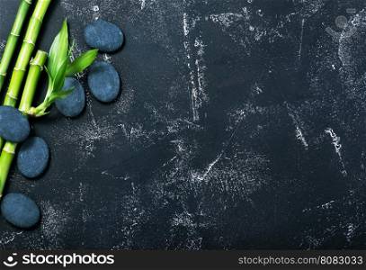 green bamboo and black basalt on a table