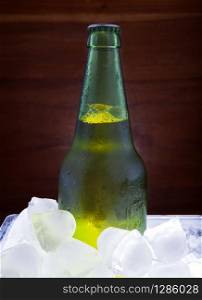 green beer bottle freezing in ice tank for beverage theme. green beer bottle freezing in ice tank