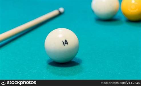Green billiard table with white balls and cue. Closeup. game of billiards