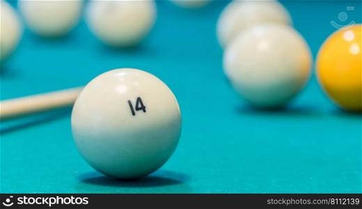 Green billiard table with white balls and cue. Closeup. game of billiards